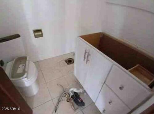 bathroom with toilet and tile patterned floors