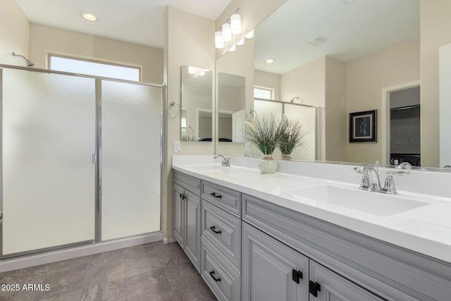 bathroom featuring vanity, a healthy amount of sunlight, and walk in shower