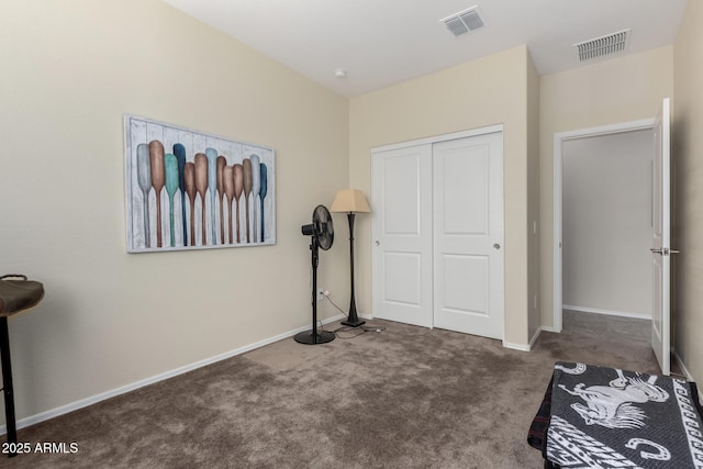 bedroom featuring dark carpet and a closet