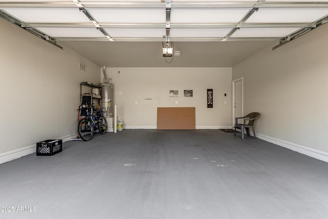 garage with a garage door opener and gas water heater