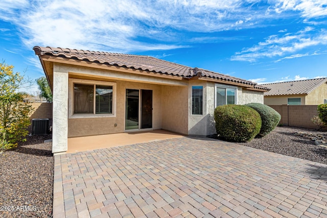 rear view of property featuring a patio and central AC unit