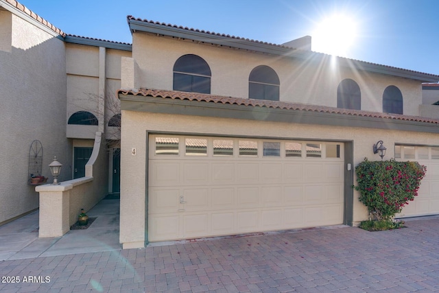 mediterranean / spanish house with a garage