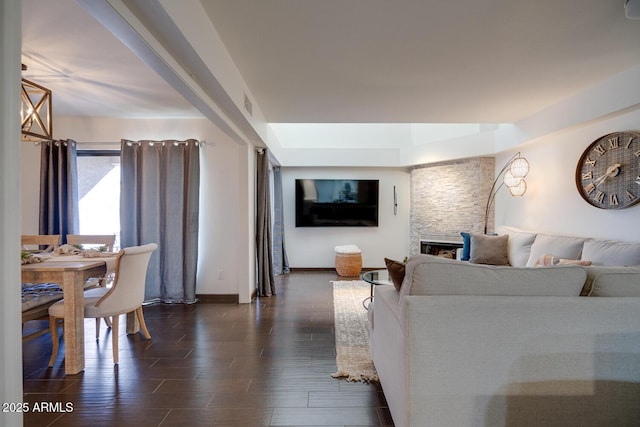 living room featuring dark hardwood / wood-style flooring and a fireplace