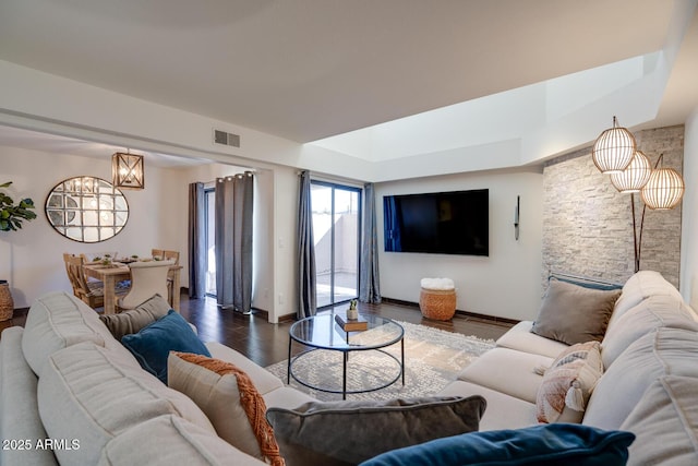 living room featuring dark wood-type flooring and a chandelier