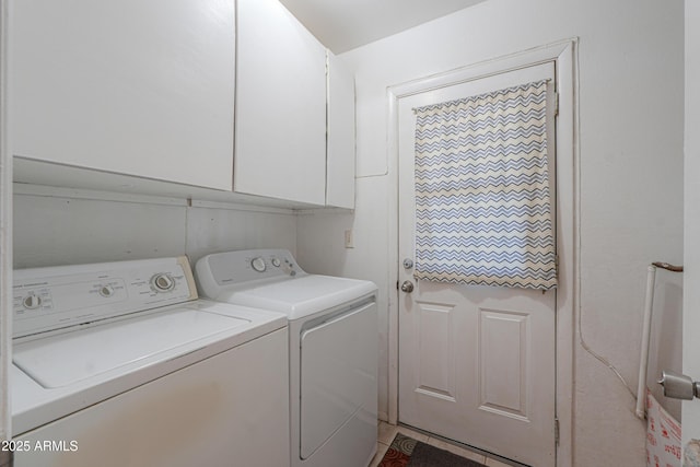 washroom featuring separate washer and dryer and cabinet space