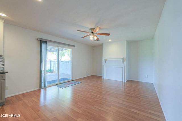 empty room featuring baseboards, light wood-type flooring, a ceiling fan, and recessed lighting