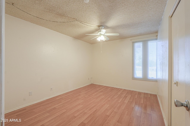 unfurnished room with a textured ceiling, a ceiling fan, light wood finished floors, and baseboards