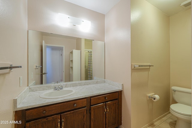 bathroom with vanity, tile patterned floors, toilet, visible vents, and baseboards