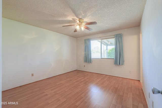 empty room with a textured ceiling, ceiling fan, and light wood-type flooring
