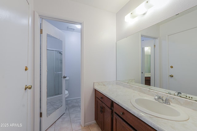 bathroom with a stall shower, baseboards, toilet, tile patterned floors, and vanity