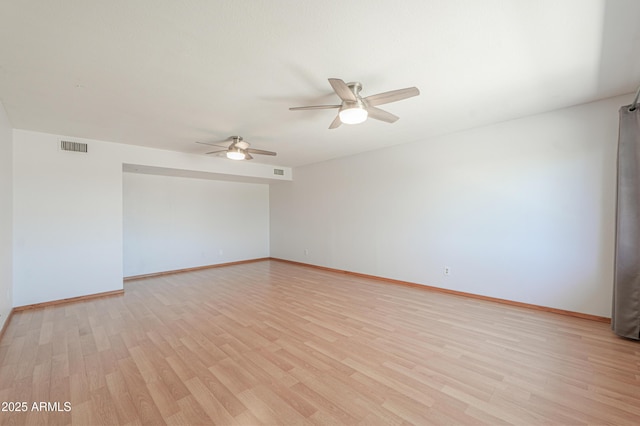 empty room featuring a ceiling fan, light wood-style flooring, and baseboards