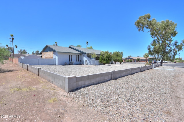 rear view of property featuring fence