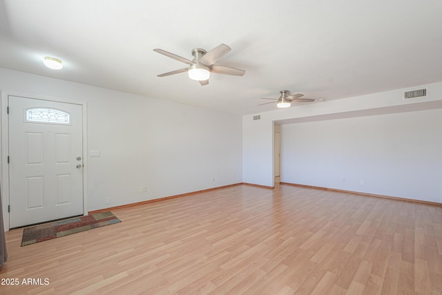entrance foyer featuring visible vents, light wood-type flooring, a ceiling fan, and baseboards