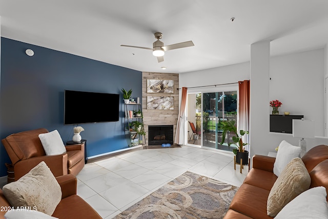 living room with a fireplace and ceiling fan