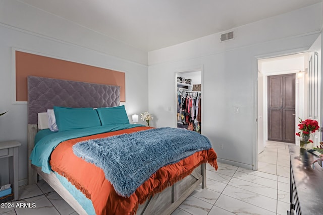 bedroom featuring a walk in closet and a closet