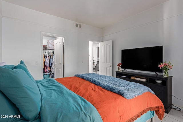 bedroom with a walk in closet and a closet