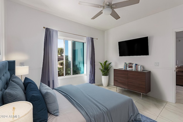 tiled bedroom featuring ceiling fan