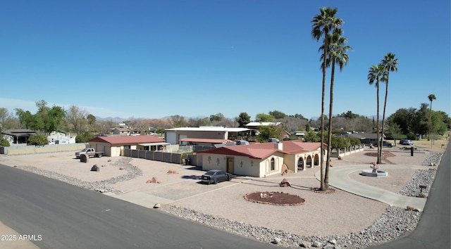 view of front facade with a residential view and fence