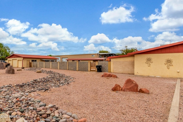 exterior space featuring fence and stucco siding