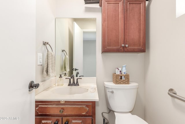 bathroom with toilet and vanity