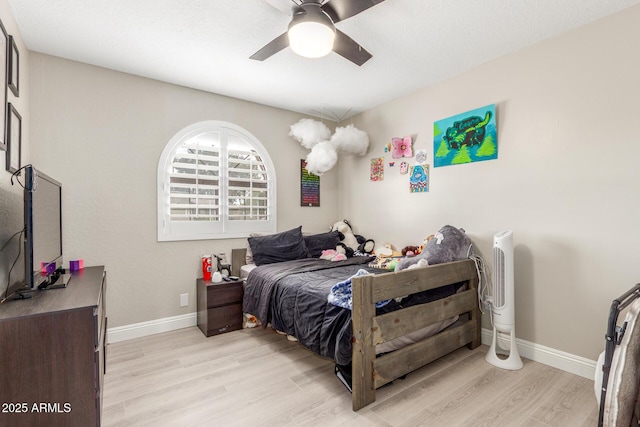 bedroom featuring baseboards, light wood-type flooring, and ceiling fan