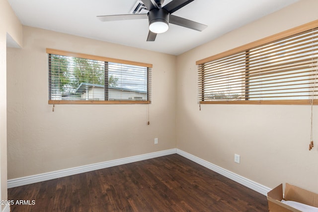 unfurnished room featuring baseboards, wood finished floors, and a ceiling fan