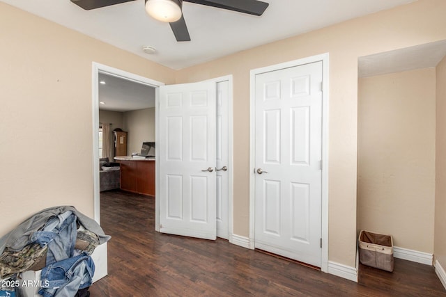 bedroom featuring ceiling fan, baseboards, and dark wood-style flooring