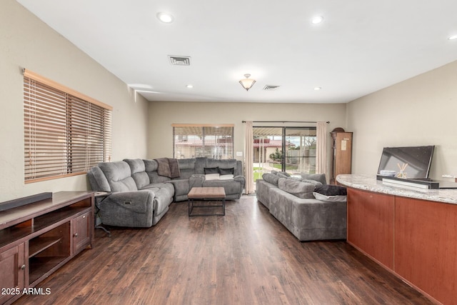 living room with dark wood finished floors, recessed lighting, and visible vents