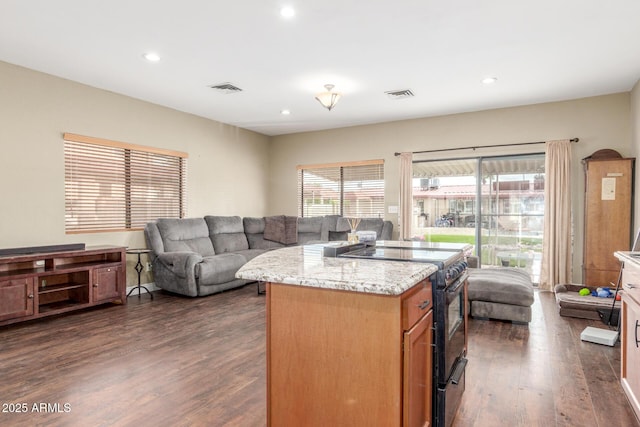 kitchen with visible vents, black / electric stove, dark wood-type flooring, and open floor plan