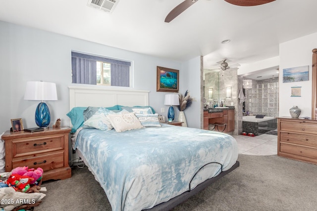 bedroom featuring visible vents, ensuite bathroom, a ceiling fan, and carpet floors