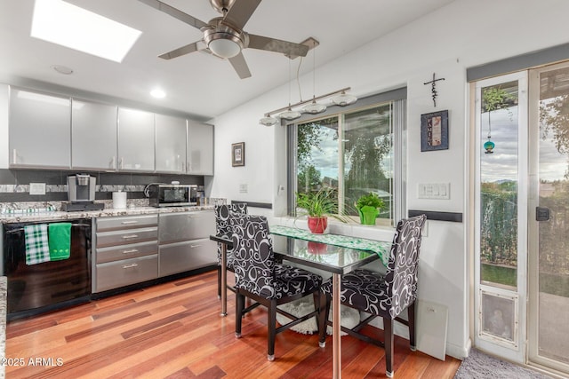 kitchen with dishwasher, light wood-style floors, a wealth of natural light, and ceiling fan