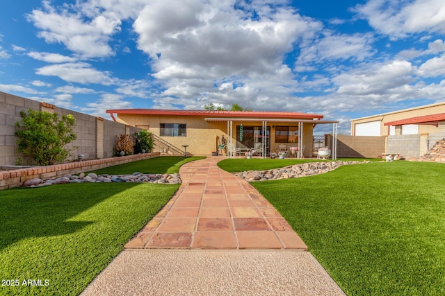 back of house featuring a fenced backyard, stucco siding, a patio, and a yard