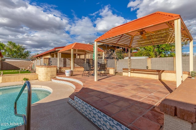 view of patio / terrace featuring a gazebo, a pool, a fenced backyard, and a ceiling fan