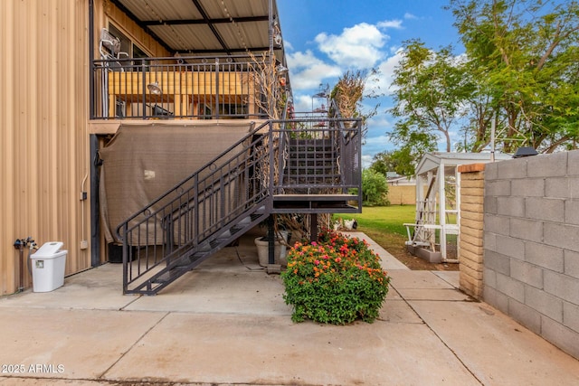 view of home's exterior featuring stairs, a patio area, and fence