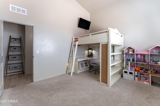 carpeted bedroom with lofted ceiling