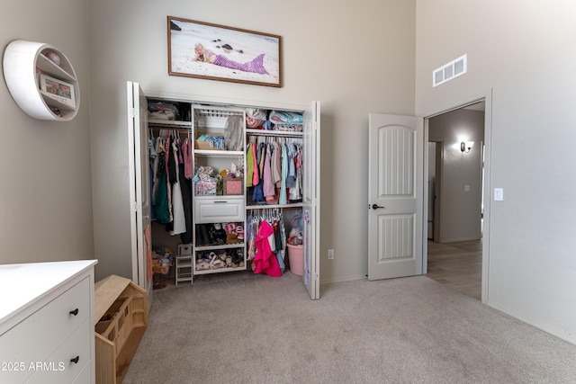 bedroom with light colored carpet and a closet