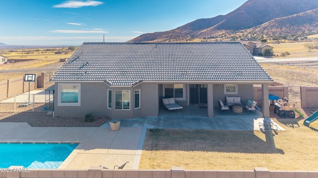 back of property with a patio area and a mountain view