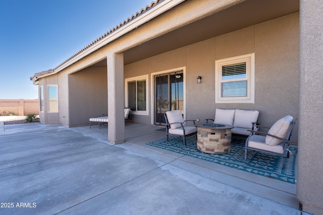 view of patio featuring an outdoor living space with a fire pit