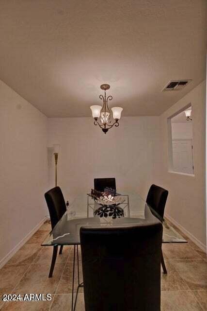 dining space with a chandelier