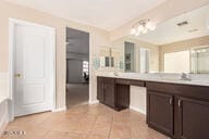 bathroom with tile patterned flooring and vanity