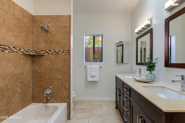 bathroom featuring baseboards, a sink, toilet, and double vanity