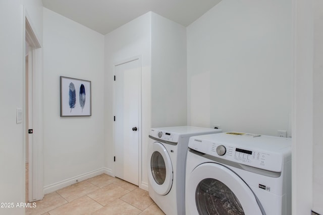 laundry room featuring laundry area, light tile patterned floors, baseboards, and washing machine and clothes dryer