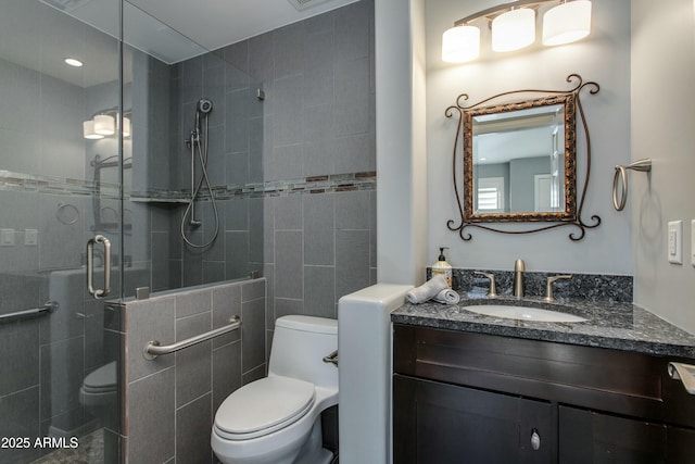 full bath featuring a stall shower, vanity, and toilet