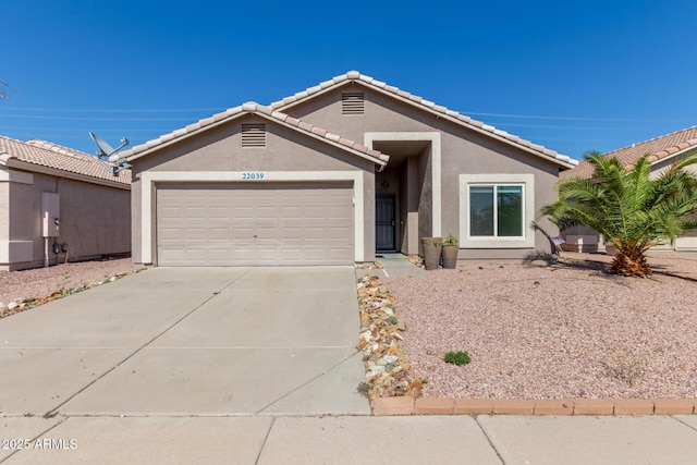 22039 N 35th Dr, Glendale, AZ 85310 - ranch-style home with stucco siding, an attached garage, driveway, and a tile roof