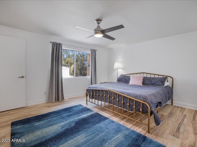 bedroom with ceiling fan and wood-type flooring