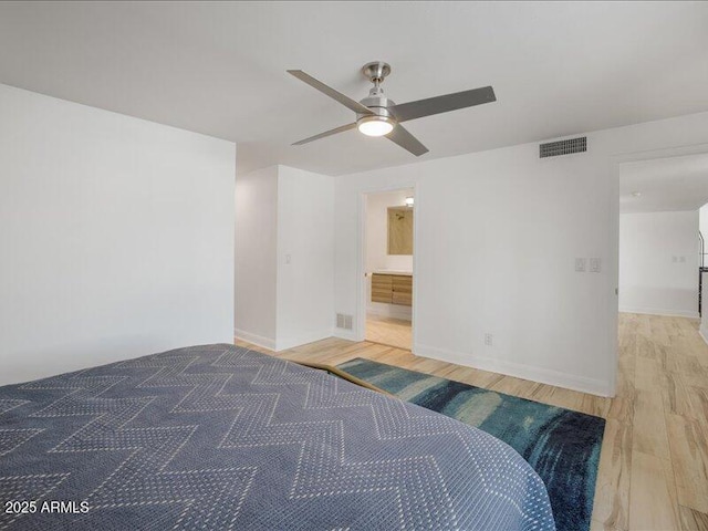 unfurnished bedroom featuring hardwood / wood-style flooring, ensuite bath, and ceiling fan