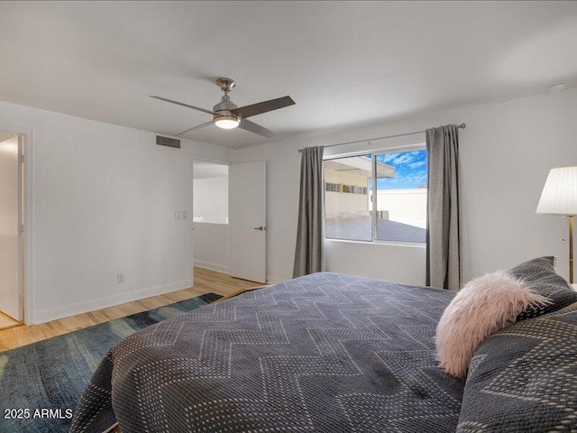 bedroom with ceiling fan and light hardwood / wood-style flooring