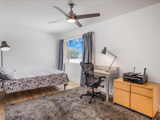 bedroom featuring dark hardwood / wood-style floors and ceiling fan