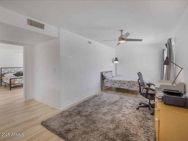 home office with hardwood / wood-style floors and ceiling fan