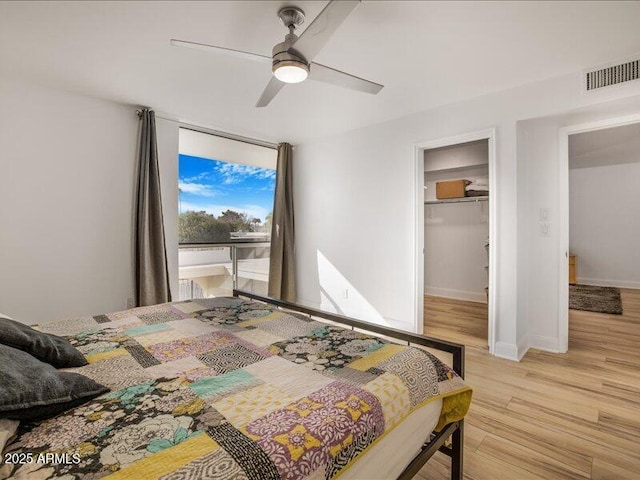 bedroom featuring ceiling fan, a closet, and light hardwood / wood-style flooring